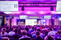 The main hall at Edition 01, Prague — packed audience under magenta stage lighting