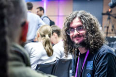 Close-up of an attendee mid-conversation in the hallway